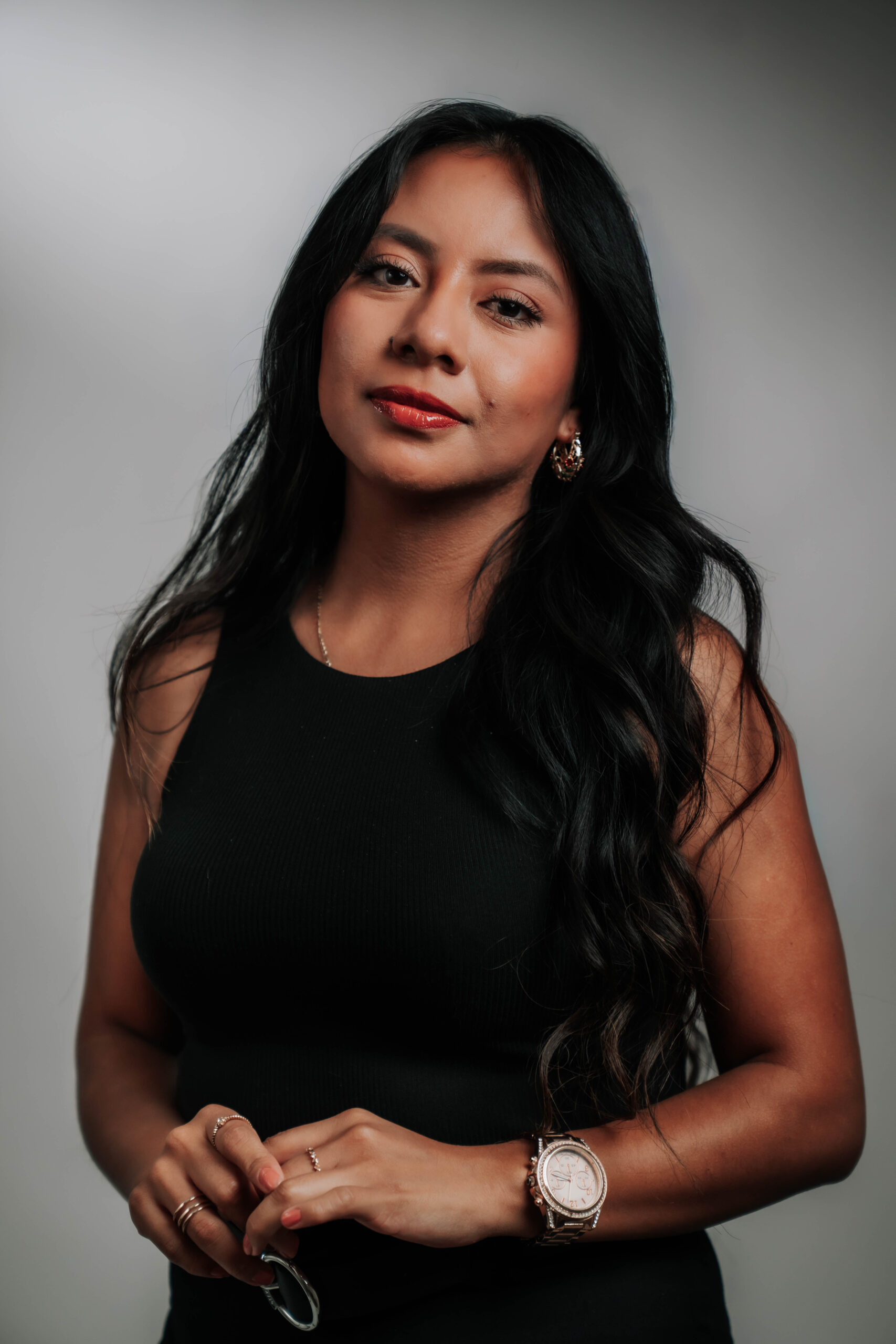 A sophisticated professional headshot of Rose Duran, Social Media Coordinator for Advine Agency. Rose's elegant style and confident gaze emphasize her strategic approach to social media management and digital presence.