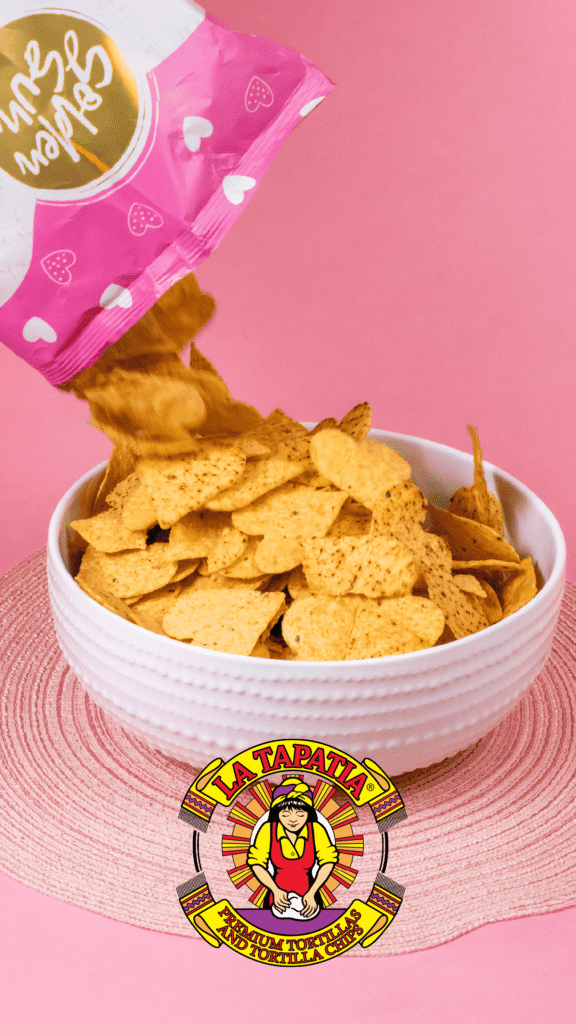 La Tapatia Advine's vibrant studio shot for La Tapatia shows golden tortilla chips pouring from a pink "Golden Sun" bag into a white bowl against a bright pink backdrop, highlighting the "Premium Tortilla Chips."