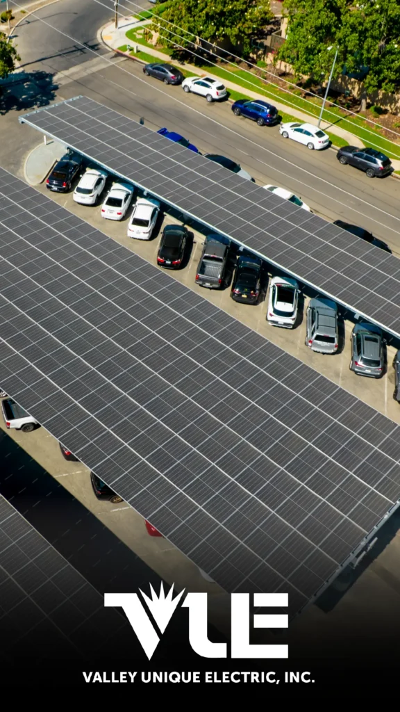 Advine's aerial photography provides a striking overhead view of a large parking lot covered by newly installed solar carports, showcasing the clean energy and large-scale commercial work of Valley Unique Electric, Inc. (VUE).